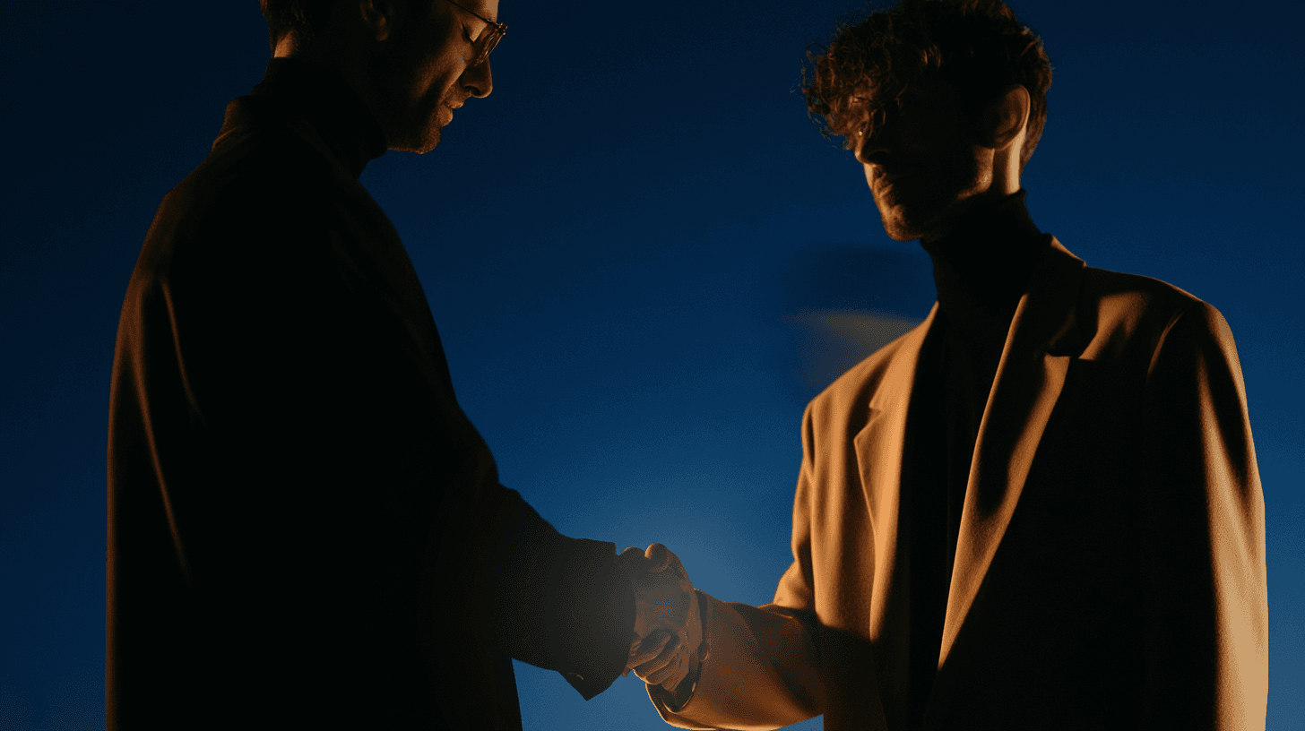 Two consultants shaking hands at the end of an engagement